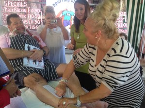 Pulling a strip off Philip's waxed legs