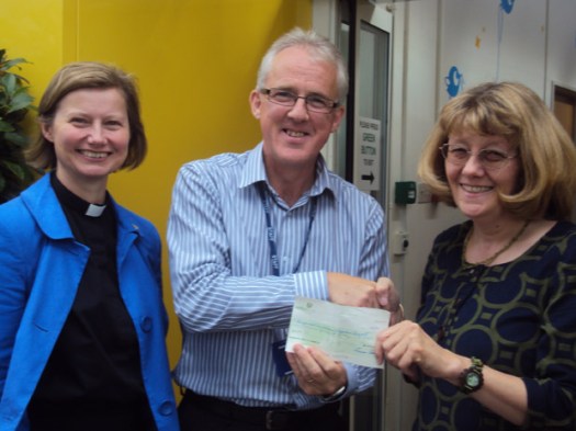 Frances Eccleston, the Priest in Charge at St. Columba's and Eileen Kehoe present the cheque to Dave Threlfall, Head of Therapies at Ryegate