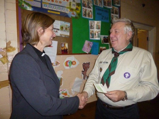 Rev. Frances Eccleston presents the money to group scout leader Michael Holmes